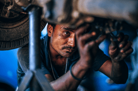 Auto Repair Technician performing maintenance on a vehicle.
