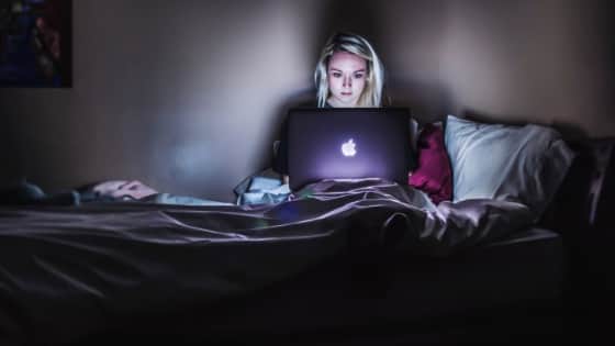 girl in bed on the computer