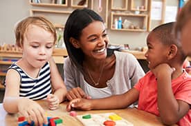 Teacher in a classroom working with kids in early childhood.