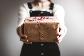 person holding out gift