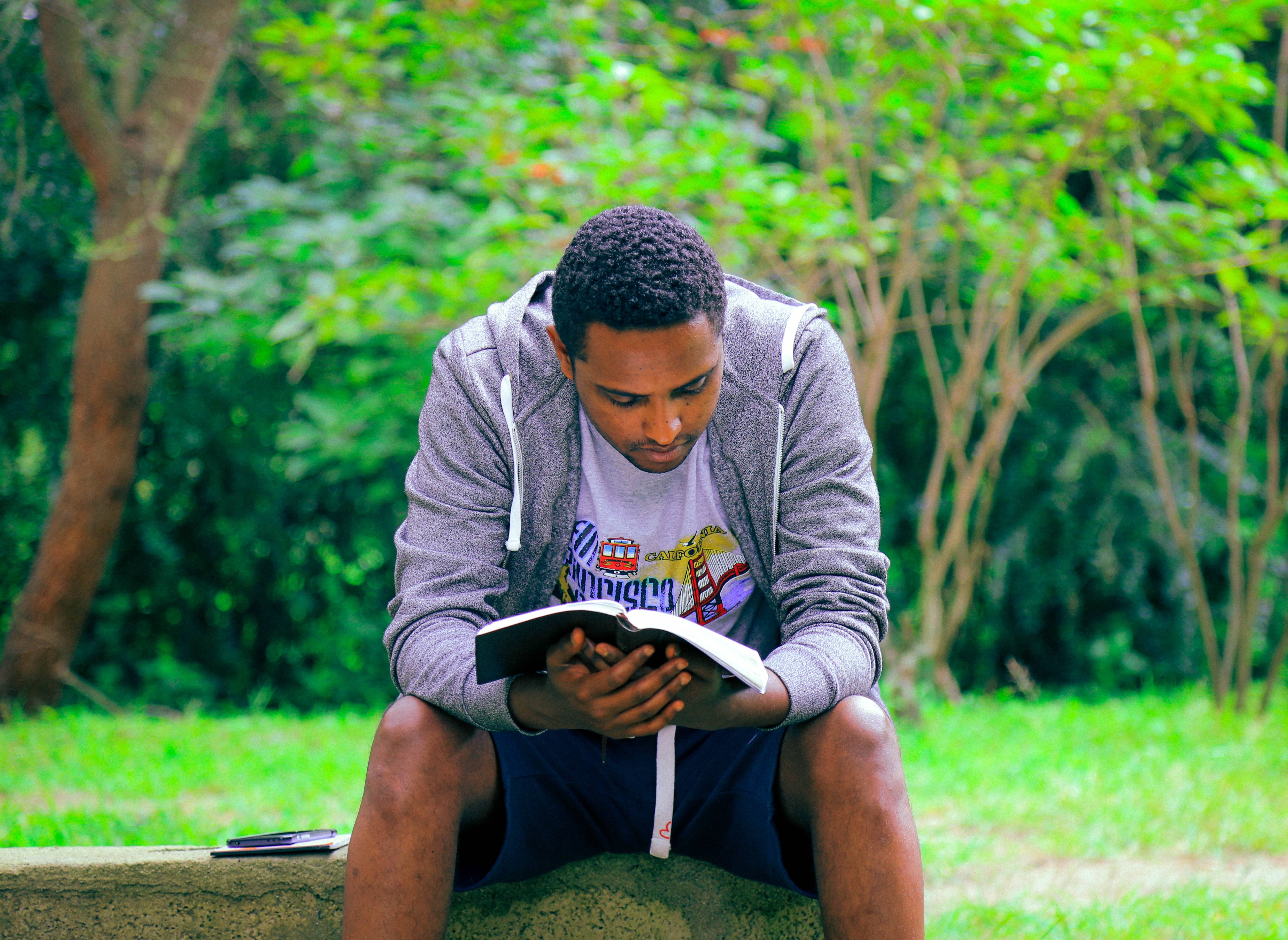 Boy Reading at Park