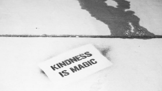 black and white photo of card that says kindness is magic