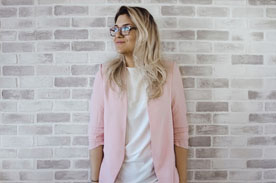 Woman next to wall