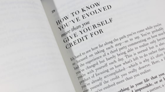 close up of book chapter titled how to know you've evolved more than you give yourself credit for.