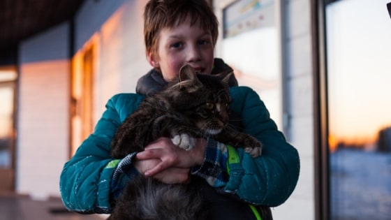 boy holding a cat