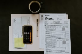 calculator and financial documents in folder.