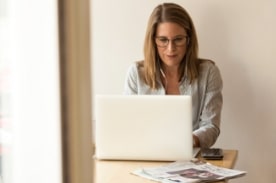 woman using white laptop.