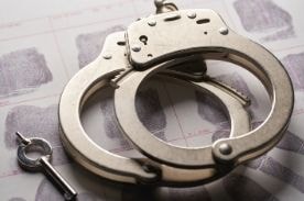 handcuffs and key on table.