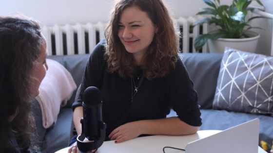 woman interviewing for podcast.