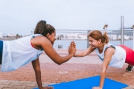 friends high five during yoga.