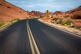 road leading to mountains in the desert