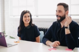 man and woman talking at table