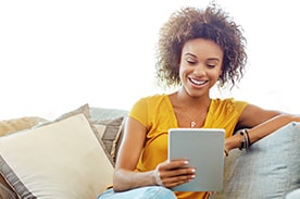 woman using silver tablet.