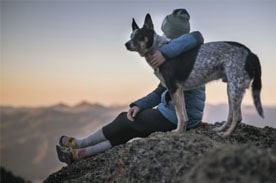 woman on mountain with dog