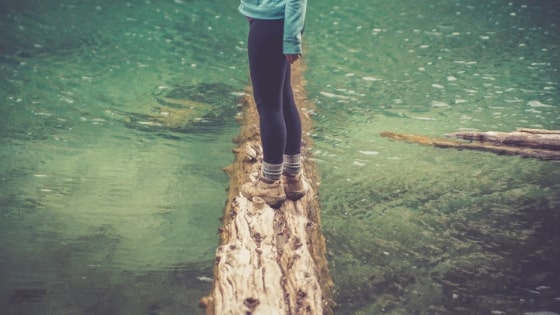 woman balancing on a log