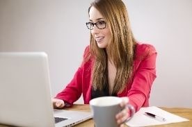 woman working on white laptop.