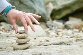 person balancing stones.