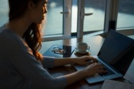 woman using laptop on table.