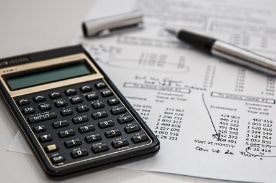 calculator and payroll paperwork.