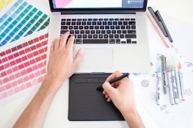person designing on a laptop.