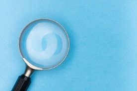 magnifying glass on blue background.