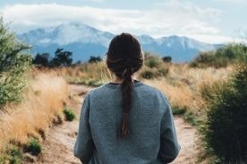 girl facing a path.
