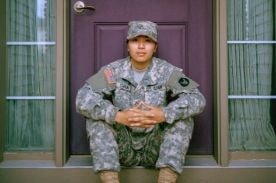 US Military recruit sitting on stoop.