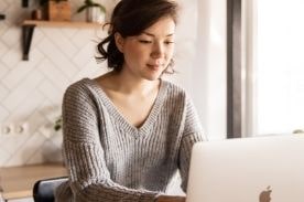 women using an apple laptop.