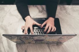 girl typing on laptop.