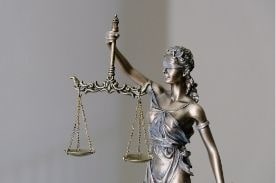 Bronze statue of Lady Justice holding scales.