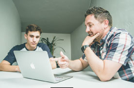 Man and boy at computer.