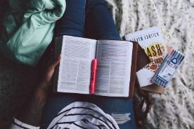 girl studying with book in lap.
