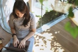 girl working on laptop outside.