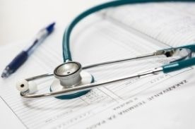 stethoscope on patient records.