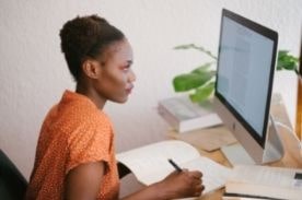 woman studying at desktop computer.