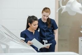 medical assistants reviewing chart.