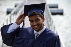 Man in graduation cap and gown.