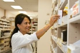 Woman reaching towards shelf.
