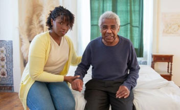 care giver helping older man.