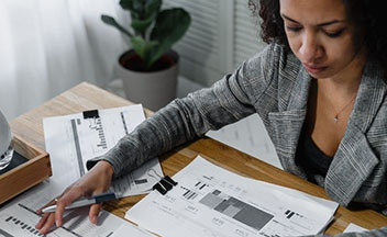 Woman at desk looking at charts.