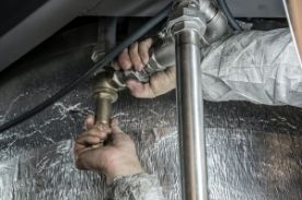 Hands tightening pipes.