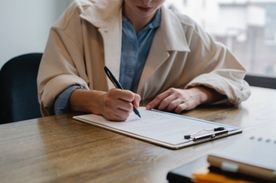 woman making notes on a resume.