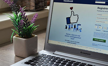 laptop displaying Facebook login screen.