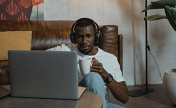man in headphones using laptop.