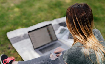 girl using laptop outdoors.