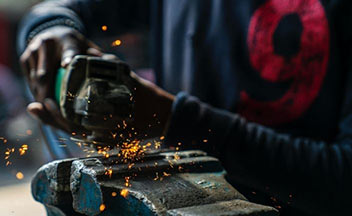person welding and soldering metal.