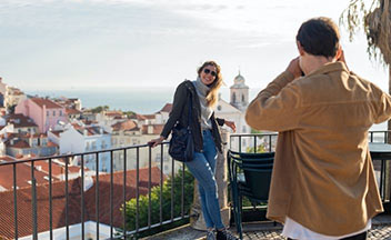 man taking photo of woman on vacation.