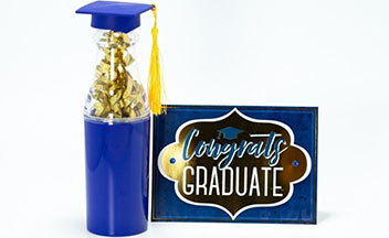 Blue bottle with gold streamers and gold graduation tassel next to a blue and black congrats graduate card.