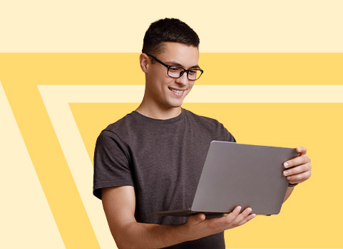 young man looking at tablet on yellow and orange background.