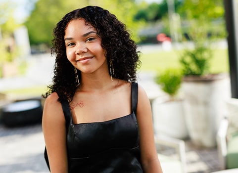 PFHS graduate, Arieonna McNeill, posing outside before graduation.